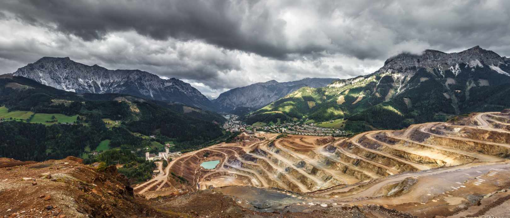 Panorama overview of Austrian mining area with green valley in the background